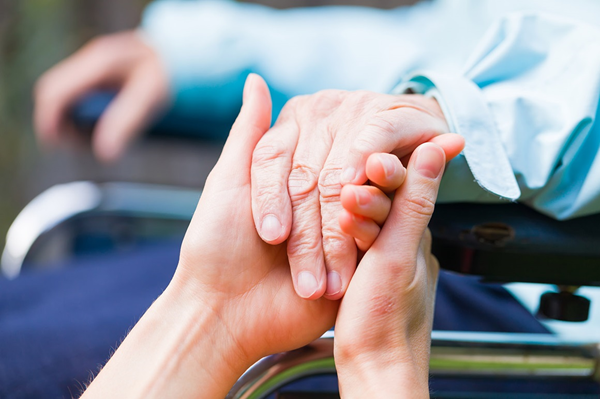 Nurse holding patients hand